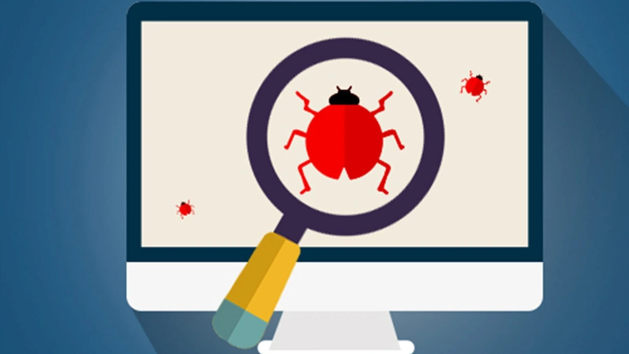 A red bug on a computer screen being focused by a magnifying glass
